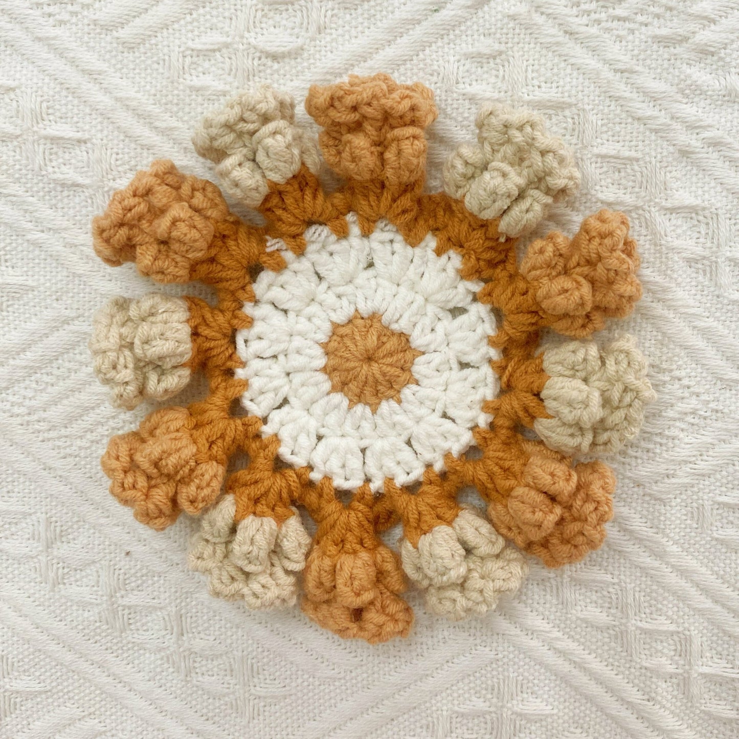 Hand-knitted Bell orchid coaster