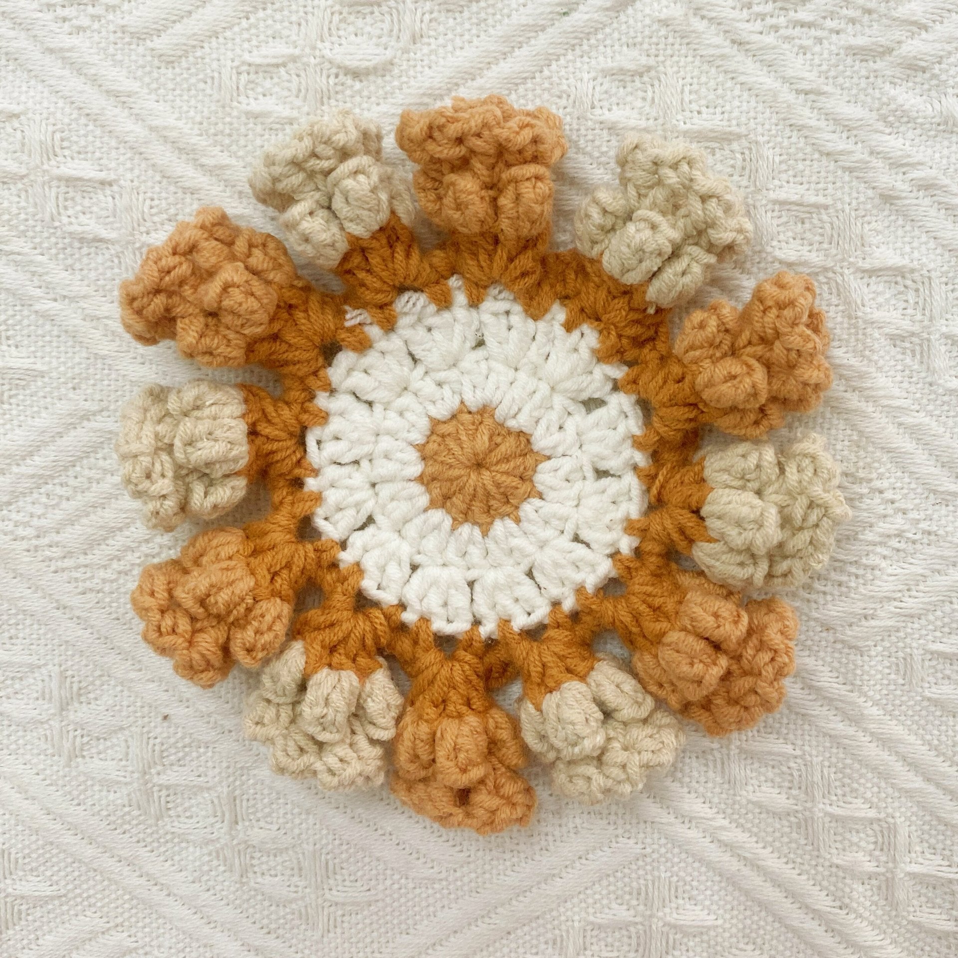 Hand-knitted Bell orchid coaster